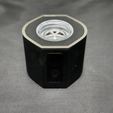 Black hydrogen water generator with power button on textured surface