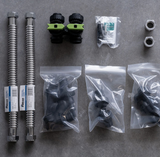 Hydrogen water system installation kit with metal hoses, adapters, and connectors on gray surface