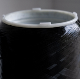 Close-up of a black hydrogen water filter cartridge with textured surface