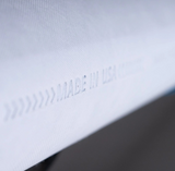 Closeup of textured white filter casing with 'Made in USA' text, hydrogen water technology