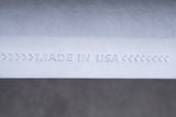 Close-up of white textured material with 'Made in USA' embossed, product manufacturing detail