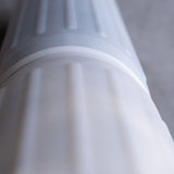 Close-up of a white hydrogen water filter cartridge with textured ridges