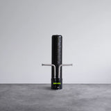 Close-up of a black hydrogen water filter system with dual metal hoses on a gray surface