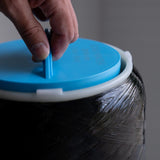 Close-up of hand adjusting blue hydrogen water filter cap