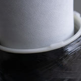 Close-up of a water filter cartridge with fine white mesh and black outer casing