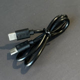 Black USB charging cable with USB-C and micro USB connectors on a dark background