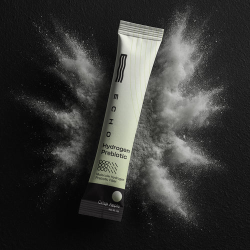 Echo hydrogen prebiotic powder stick labeled Crisp Apple on black textured background with white powder burst